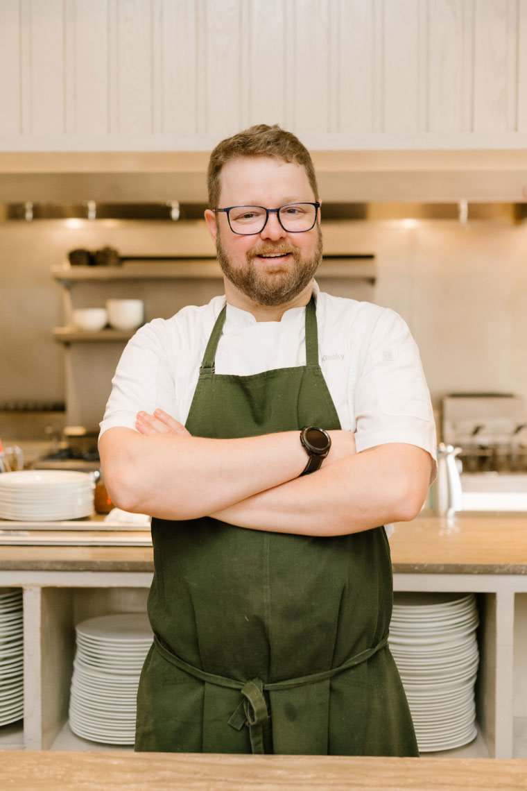 Chef Micah Klasky standing in kitchen